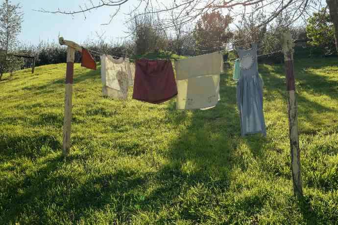 Laundry is drying on a clothesline outdoors.